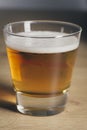 Blond beer with froth on a glass pot on a wooden board Royalty Free Stock Photo