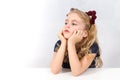 Bored little girl sitting at table Royalty Free Stock Photo