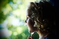 Blond blue eyed little girl looking out the window Royalty Free Stock Photo