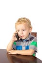 Blond boy careful talking on a cell phone