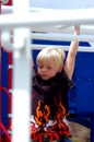 Blond Boy Child On Bars Royalty Free Stock Photo
