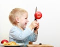 Blond boy child kid preschooler with kitchen knife cutting fruit apple Royalty Free Stock Photo