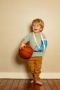 Blond boy hold basketball ball with broken hand in plaster cast Royalty Free Stock Photo