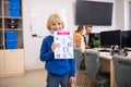 Blond boy holding paper with physics drawings Royalty Free Stock Photo