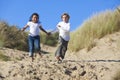 Blond Boy & Mixed Race Girl Running At Beach Royalty Free Stock Photo