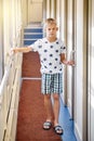 Blond boy opens door into train compartment entering coupe