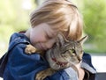 Blond boy with oriental bred cat Royalty Free Stock Photo