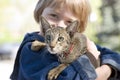 Blond boy with oriental bred cat Royalty Free Stock Photo