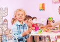 Blond boy in preschool class sit by table Royalty Free Stock Photo