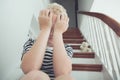 Blond boy pressing hands to face with teddy bear