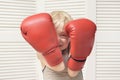 Blond boy is protected in two boxing gloves. Portrait Royalty Free Stock Photo