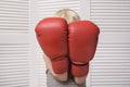 Blond boy is protected in two boxing gloves. Portrait Royalty Free Stock Photo