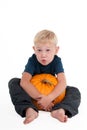 Blond boy with a pumpkin Royalty Free Stock Photo