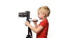 Blond boy shoots video on DSLR camera. Side view. White background, isolate