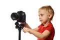 Blond boy shoots video on DSLR camera. Front view. White background, isolate Royalty Free Stock Photo