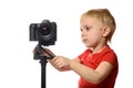 Blond boy shoots video on DSLR camera. Front view. White background, isolate Royalty Free Stock Photo