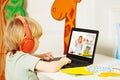 Blond boy watch education videos over internet on laptop Royalty Free Stock Photo