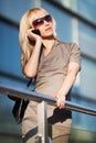 Fashion blond woman in sunglasses calling on mobile phone Royalty Free Stock Photo