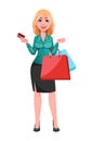 Young successful business woman holding credit card and shopping bags Royalty Free Stock Photo