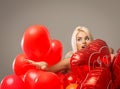 Blond cheerful woman with red balloons heart