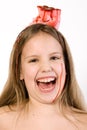 Blond child with desert on her head laughing