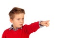 Blond child with red jersey pointing with his finger