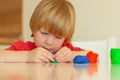 blond child sculpts with plasticine. children\'s entertainment, leisure, activities, educational games