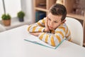 Blond child tired studying at home Royalty Free Stock Photo