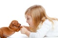 Blond children girl with dog puppy mini pinscher