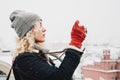 Blond curly girl shooting on film photo camera, winter Royalty Free Stock Photo