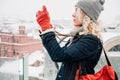 Blond curly girl shooting on film photo camera, winter Royalty Free Stock Photo