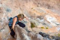 Blond Cute Climber on rocky terrain makes difficult move Royalty Free Stock Photo