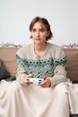 Blond european girl playing video games in her home