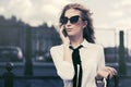 Blond fashion business woman in sunglasses calling on cell phone on city street Royalty Free Stock Photo