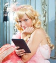 Blond fashion princess woman reading ebook tablet