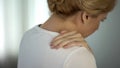 Blond female feeling terrible shoulder pain, nerve inflammation, therapy Royalty Free Stock Photo