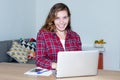 Blond female student with computer looking at camera Royalty Free Stock Photo