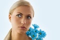 Blond girl and blue daisy Royalty Free Stock Photo