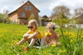 Blond girl and boy in sunglasses sit in grass on meadow. Children rest in dandelion field. Happy child summer outdoors Royalty Free Stock Photo