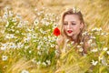 Blond girl on the camomile field Royalty Free Stock Photo