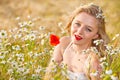 Blond girl on the camomile field Royalty Free Stock Photo