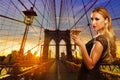 Blond girl cheers with vermout cup in NYC sunset Royalty Free Stock Photo