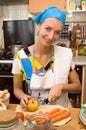 Blond girl cooking in the kitchen Royalty Free Stock Photo