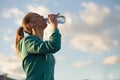 Blond girl drinking water after sport activities Royalty Free Stock Photo