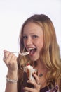 Blond girl enjoying a hot fudge sundae