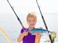 Blond girl fishing bonito Sarda tuna trolling sea Royalty Free Stock Photo