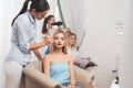A blond girl is given make-up in a beauty salon. The girl is doing makeup with applying eye shadows. Royalty Free Stock Photo