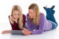 Blond girl and her mother using tablet PC Royalty Free Stock Photo