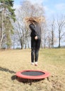 Blond girl jumping on trampoline