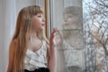 Blond girl looking out the window Royalty Free Stock Photo